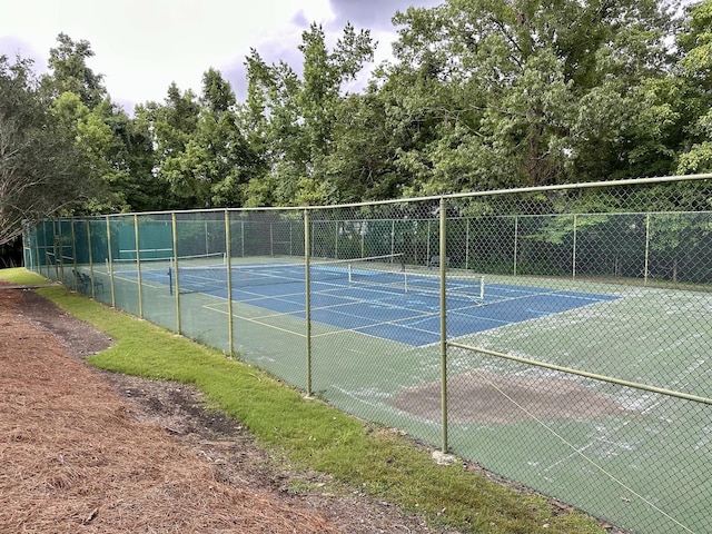 view of sport court featuring fence