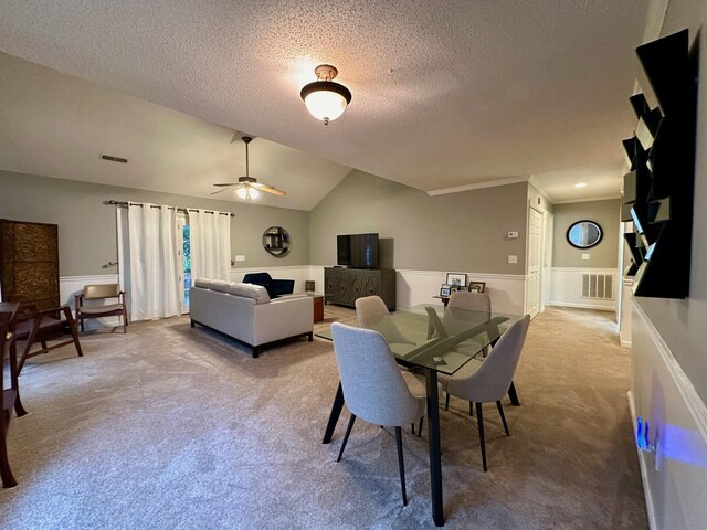 interior space featuring a textured ceiling, vaulted ceiling, and ceiling fan