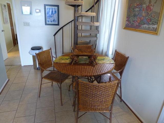 237 Driftwood Ln, Edisto Island, SC 29438 - dining space featuring light tile patterned floors, baseboards, and stairs