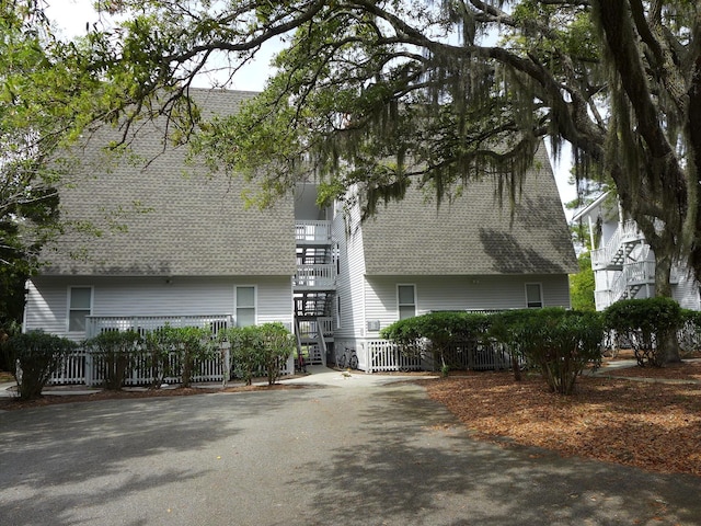 237 Driftwood Ln, Edisto Island, SC 29438 - view of front of property featuring roof with shingles, driveway, and stairs