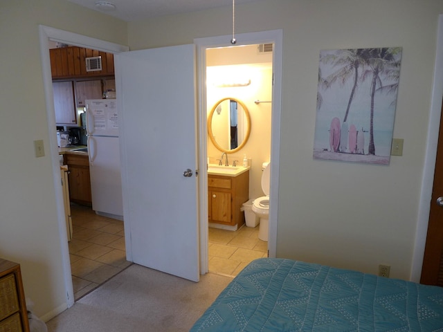 237 Driftwood Ln, Edisto Island, SC 29438 - bedroom with a sink, visible vents, freestanding refrigerator, and light tile patterned floors