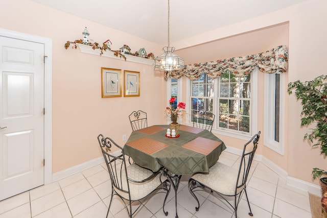 tiled dining room featuring an inviting chandelier