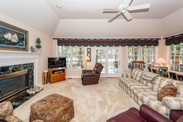 living room with lofted ceiling, plenty of natural light, a fireplace, and carpet floors