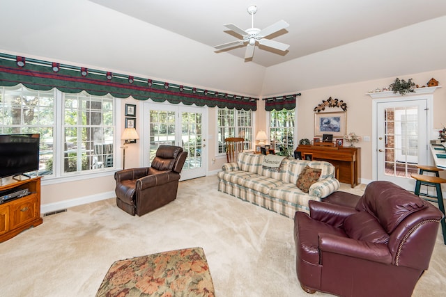 carpeted living room featuring french doors, ceiling fan, and vaulted ceiling