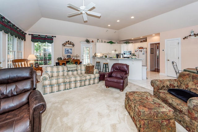 living room with light carpet, lofted ceiling, and ceiling fan