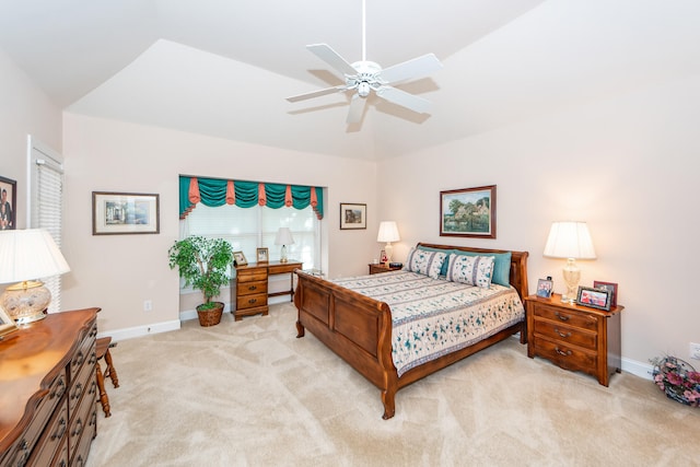 bedroom featuring lofted ceiling, light colored carpet, and ceiling fan