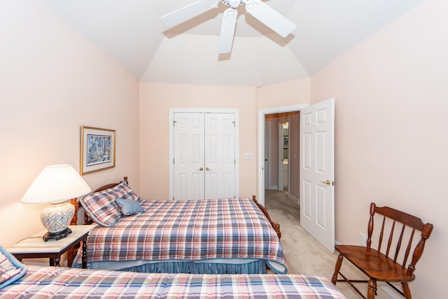 bedroom with lofted ceiling, light carpet, a closet, and ceiling fan