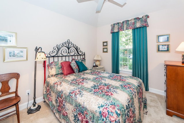 carpeted bedroom with vaulted ceiling and ceiling fan