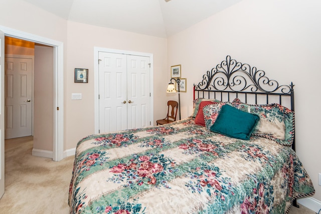 carpeted bedroom featuring a closet and lofted ceiling