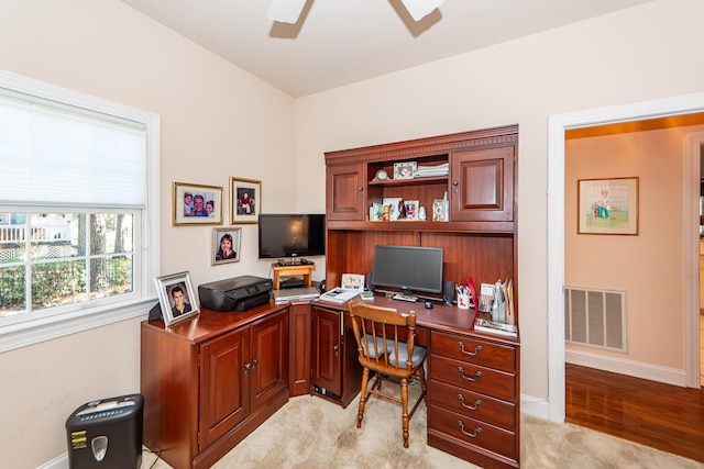 carpeted office with ceiling fan