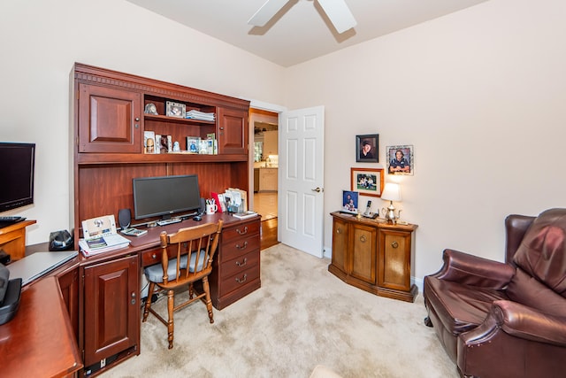 carpeted office space featuring ceiling fan