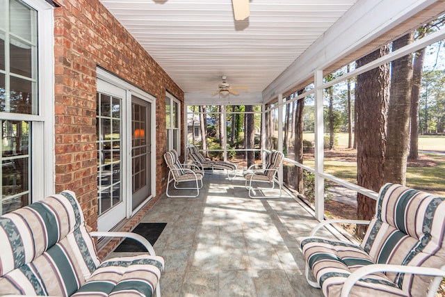 sunroom / solarium featuring ceiling fan