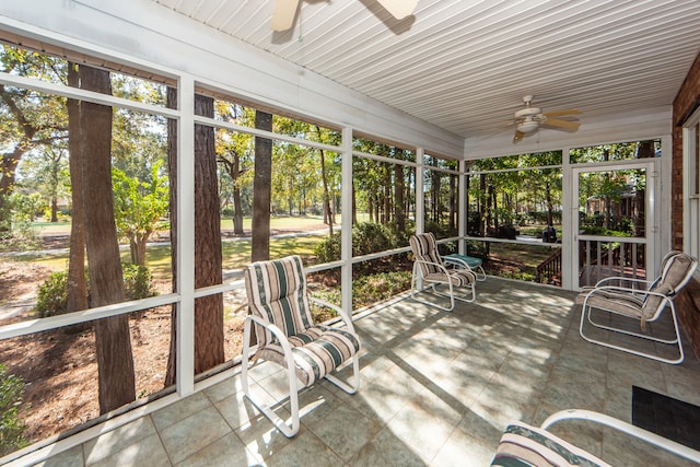 unfurnished sunroom with ceiling fan