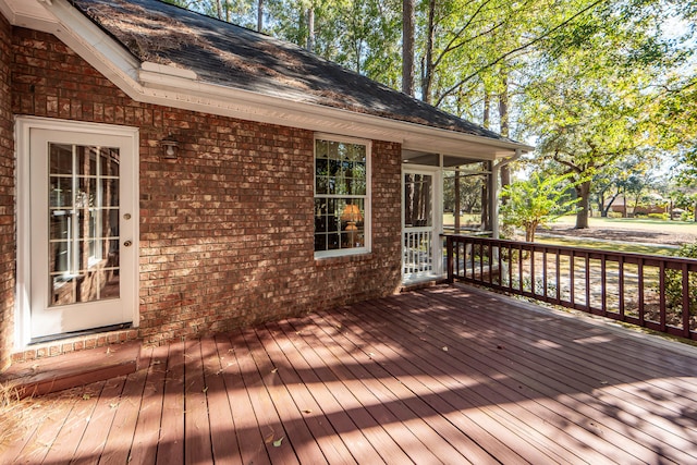 wooden deck with a sunroom