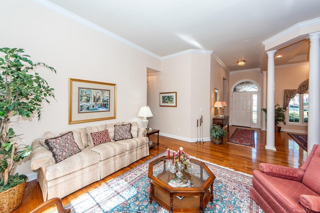 living room with ornamental molding, decorative columns, and wood-type flooring