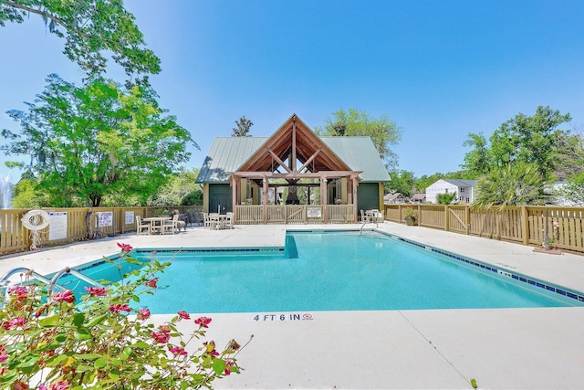 community pool with fence and a gazebo