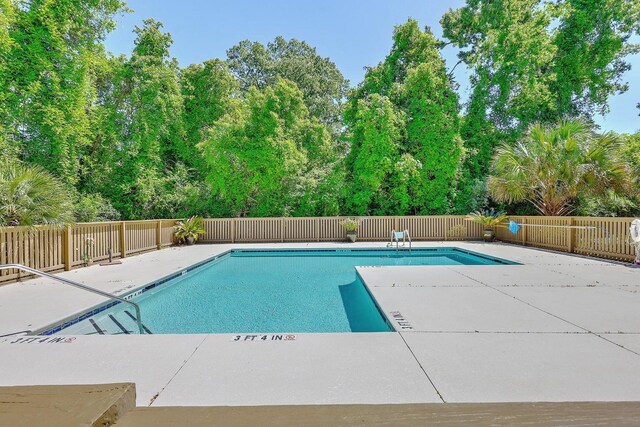 pool featuring a patio and fence