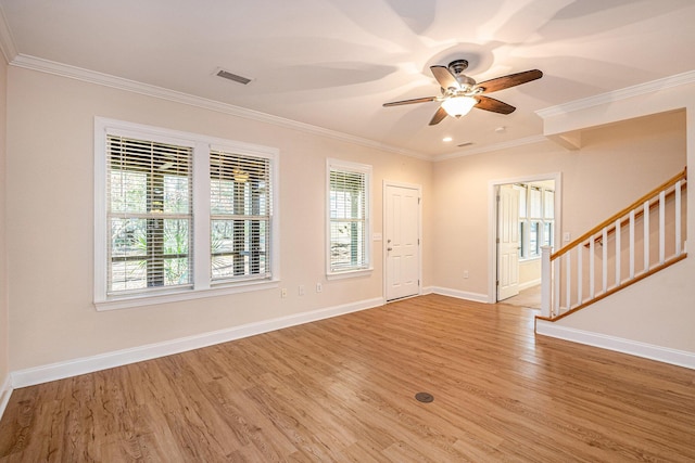 foyer entrance with stairway, light wood-type flooring, ceiling fan, baseboards, and visible vents