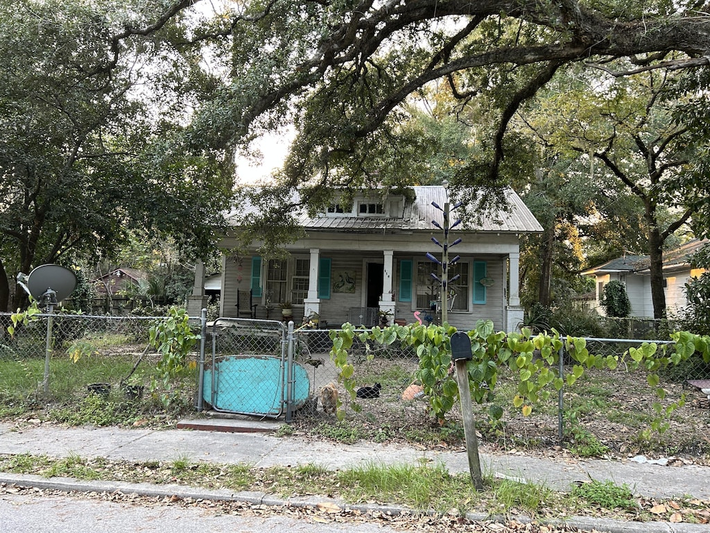116 Morral, Walterboro, SC 29488 - bungalow-style home featuring a gate, covered porch, a fenced front yard, and metal roof