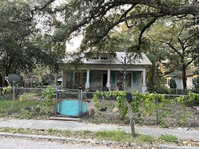 116 Morral, Walterboro, SC 29488 - bungalow-style home featuring a gate, covered porch, a fenced front yard, and metal roof