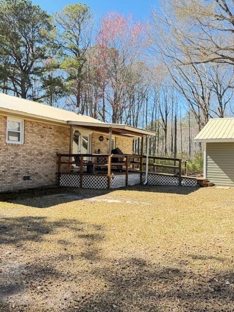 1188 Blackberry Bush Rd, Summerton, SC 29148 - rear view of house with brick siding, crawl space, and a deck