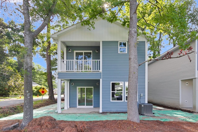 back of house with central AC unit and a balcony