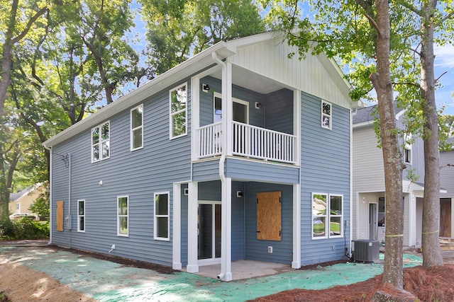 rear view of property featuring a balcony and central air condition unit