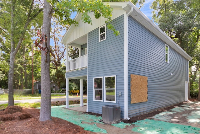 view of side of home with a balcony and central air condition unit