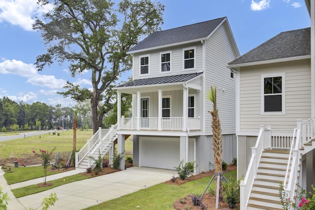 3029 Robeson Trce, Johns Island, SC 29455 - coastal home featuring stairway, covered porch, driveway, a standing seam roof, and a front lawn