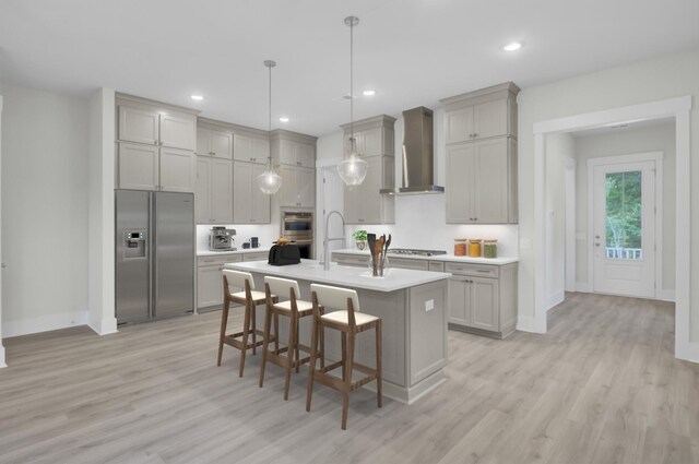 3029 Robeson Trce, Johns Island, SC 29455 - kitchen with appliances with stainless steel finishes, wall chimney range hood, light wood-style floors, light countertops, and recessed lighting