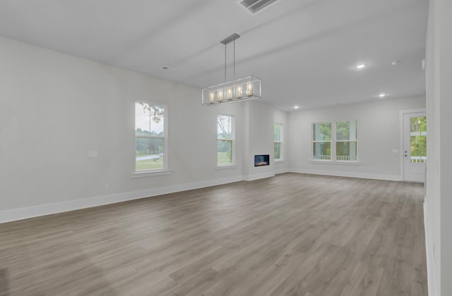 3029 Robeson Trce, Johns Island, SC 29455 - unfurnished living room featuring light wood-style flooring, healthy amount of natural light, baseboards, and recessed lighting