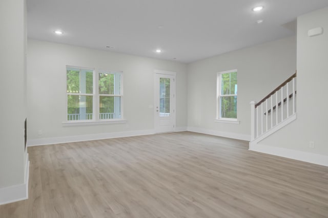 3029 Robeson Trce, Johns Island, SC 29455 - unfurnished living room featuring light wood-type flooring, stairway, baseboards, and recessed lighting