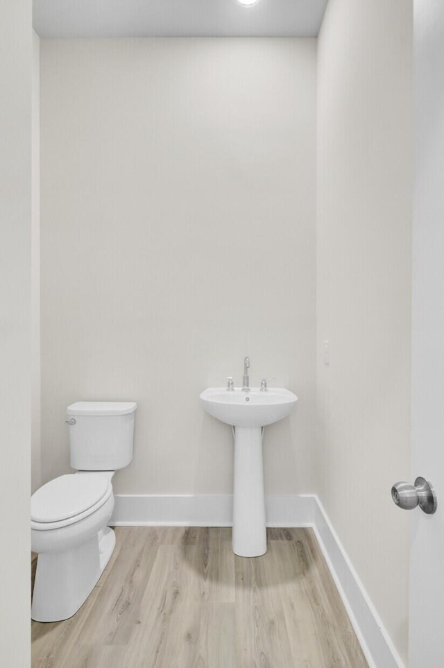 3029 Robeson Trce, Johns Island, SC 29455 - bathroom featuring toilet, wood finished floors, and baseboards