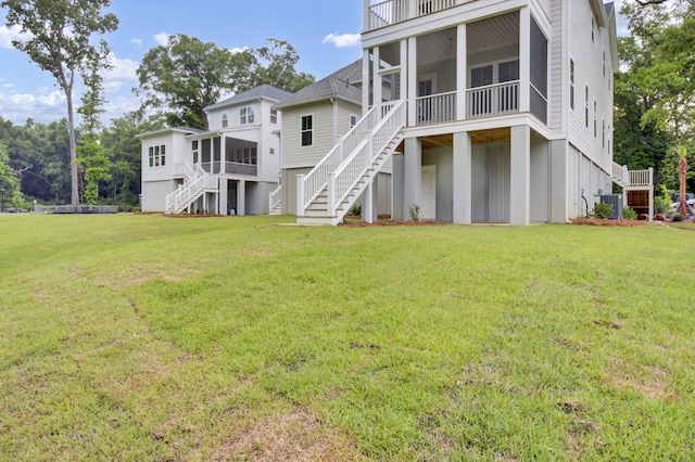 3029 Robeson Trce, Johns Island, SC 29455 - back of property with stairs, a sunroom, central AC, and a yard