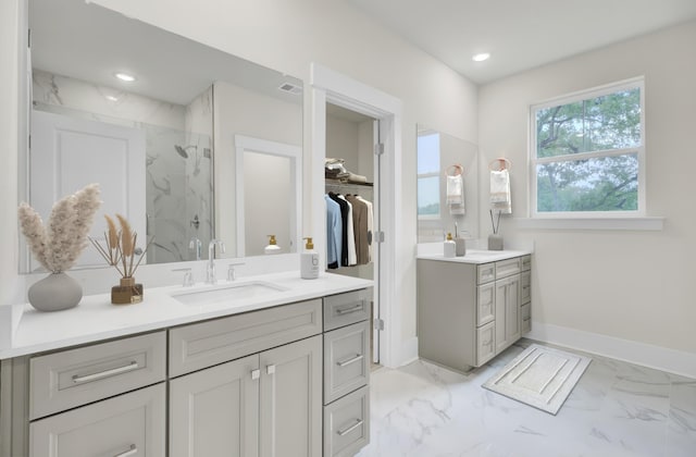 3029 Robeson Trce, Johns Island, SC 29455 - bathroom featuring a marble finish shower, vanity, marble finish flooring, baseboards, and a spacious closet