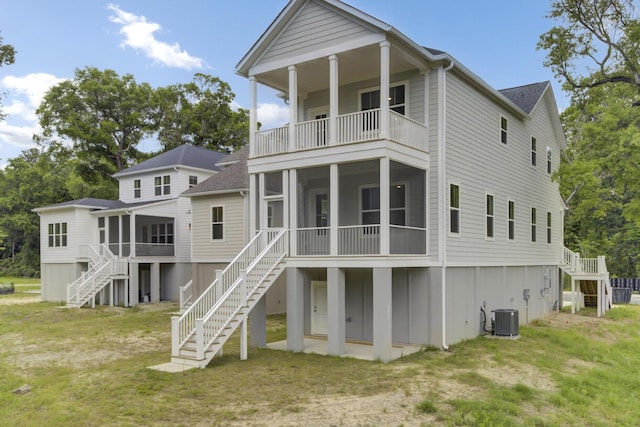 3029 Robeson Trce, Johns Island, SC 29455 - rear view of house with stairway, a sunroom, a balcony, central AC unit, and a yard