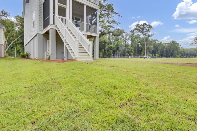 3029 Robeson Trce, Johns Island, SC 29455 - view of grassy yard featuring stairs and a sunroom