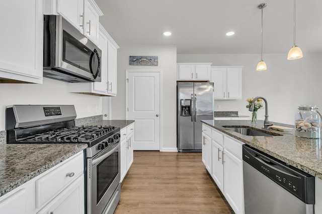 9706 Fanning Basket Ln, Ladson, SC 29456 - kitchen featuring a sink, appliances with stainless steel finishes, white cabinets, and dark stone counters