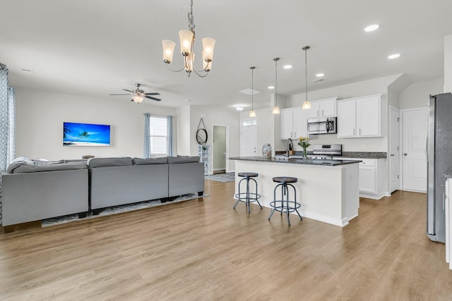 9706 Fanning Basket Ln, Ladson, SC 29456 - kitchen with ceiling fan with notable chandelier, stainless steel appliances, white cabinetry, and open floor plan