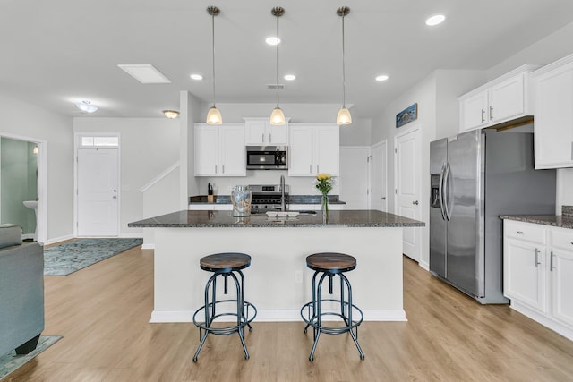9706 Fanning Basket Ln, Ladson, SC 29456 - kitchen featuring appliances with stainless steel finishes, light wood-style flooring, and white cabinetry