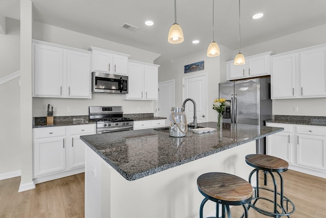 9706 Fanning Basket Ln, Ladson, SC 29456 - kitchen featuring visible vents, white cabinets, a sink, light wood finished floors, and appliances with stainless steel finishes