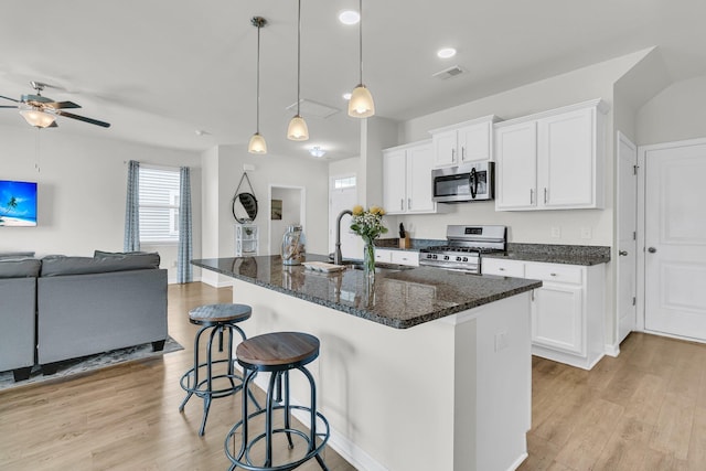 9706 Fanning Basket Ln, Ladson, SC 29456 - kitchen featuring a ceiling fan, a sink, open floor plan, a breakfast bar, and stainless steel appliances