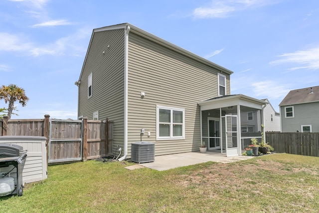 9706 Fanning Basket Ln, Ladson, SC 29456 - rear view of property featuring central AC unit, a sunroom, a fenced backyard, a yard, and a patio