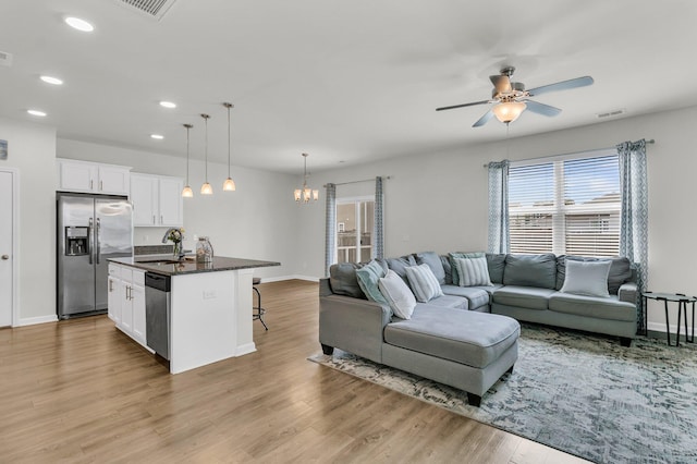 9706 Fanning Basket Ln, Ladson, SC 29456 - living room with visible vents, wood finished floors, baseboards, ceiling fan with notable chandelier, and recessed lighting