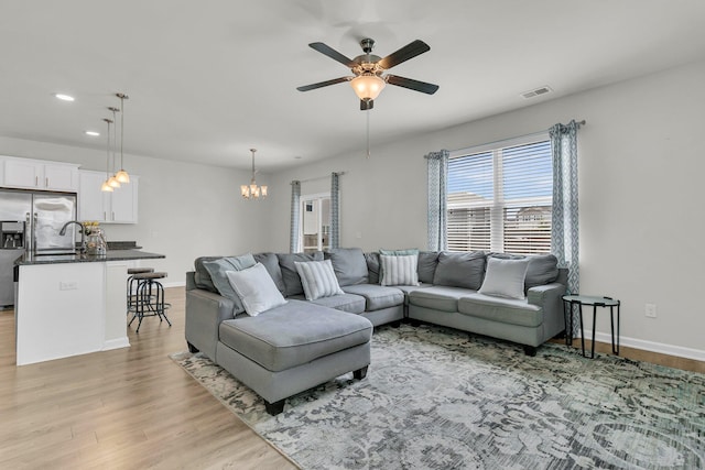 9706 Fanning Basket Ln, Ladson, SC 29456 - living room featuring visible vents, baseboards, ceiling fan with notable chandelier, light wood finished floors, and recessed lighting