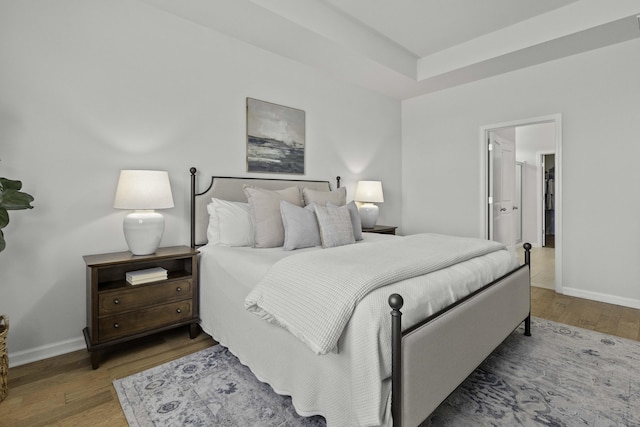 bedroom featuring baseboards and wood finished floors