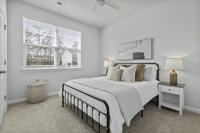 carpeted bedroom featuring baseboards, visible vents, and a ceiling fan