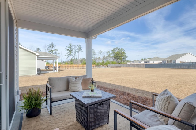 view of patio with outdoor lounge area and fence