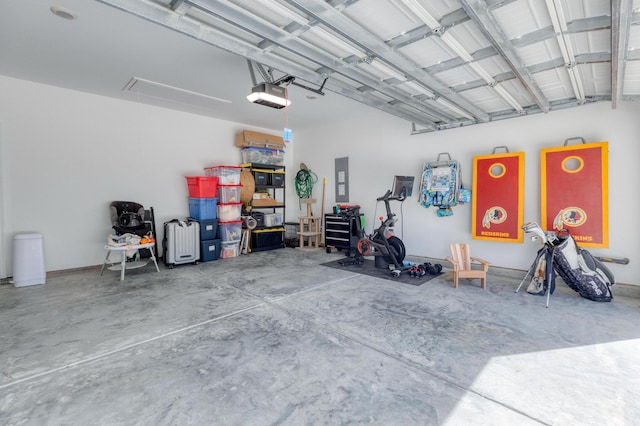 garage with a garage door opener and electric panel