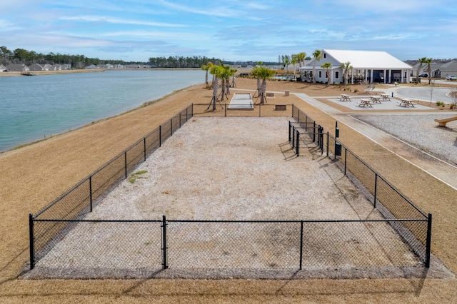 exterior space featuring a water view and fence